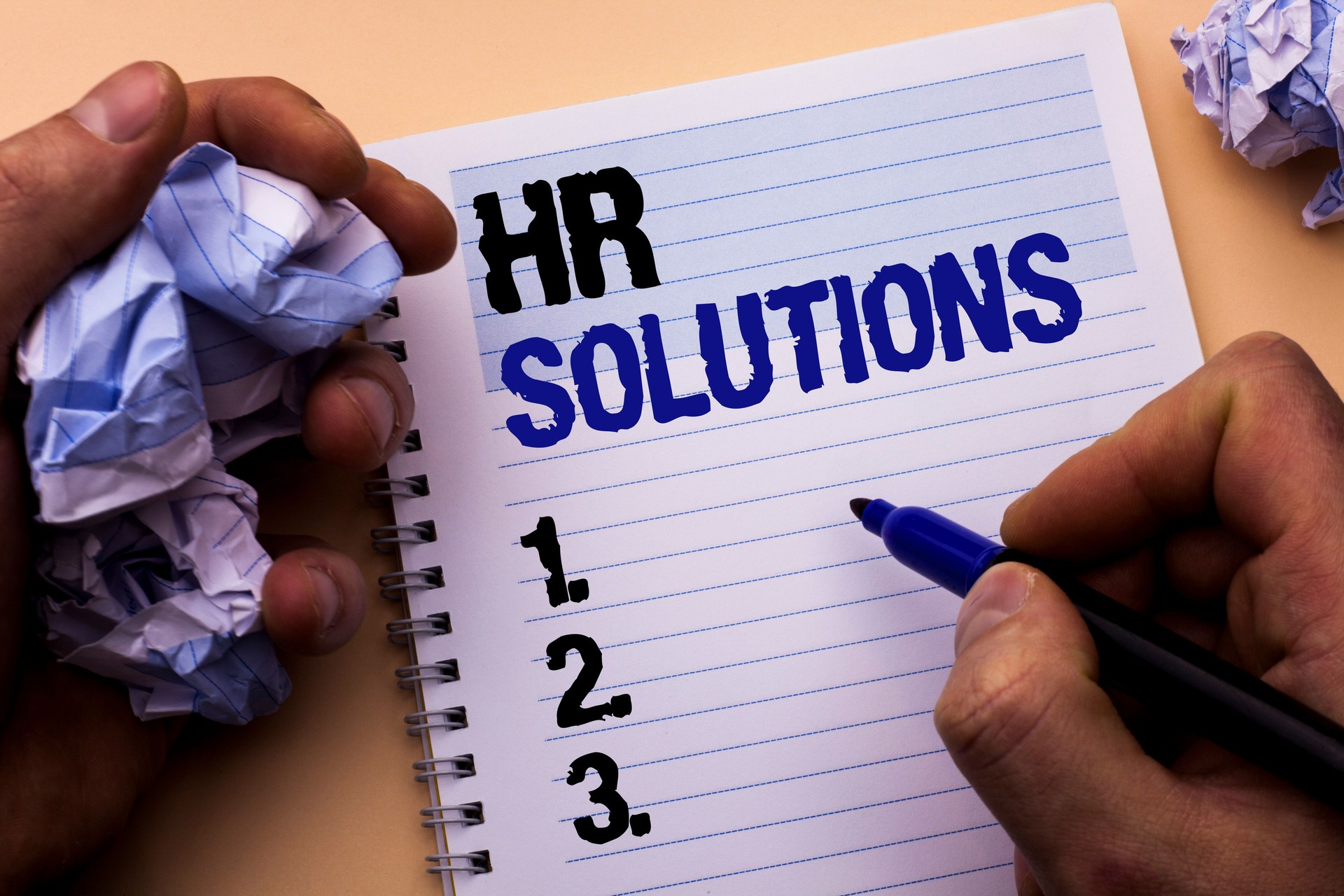 Handwriting text Hr Solutions. Concept meaning Recruitment Solution Consulting Management Solving Onboarding written by Man on Notebook Book Holding Marker on the plain background.